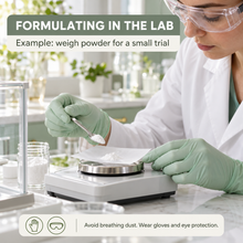 Load image into Gallery viewer, A woman in a lab coat and safety goggles weighs white powder on a digital scale in a bright laboratory setting. Text overlays read 'FORMULATING IN THE LAB' and 'Example: weigh powder for a small trial,' with a safety note at the bottom.
